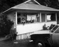Woman on veranda, Waipu Cove