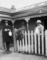 Two ladies knitting at gate